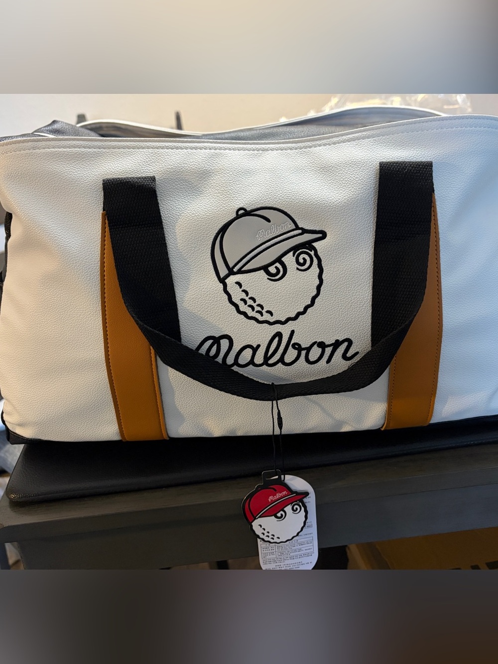 Malbon White and Black duffel or weekender bag.